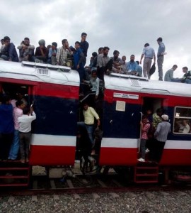 passengers on roof of rail coahces